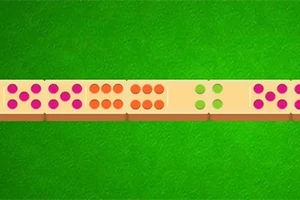 Domino-brickor med färgglada prickar på en grön bakgrund