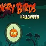 Halloween-tema med silhuetter av träd på en mörk bakgrund och en orange pumpa med texten PLAY i mitten