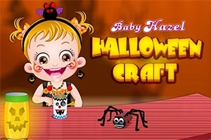 Barn med Halloween-tema pyssel, inklusive en papperstrumma med dekorationer och en leksaksspindel på ett bord