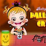 Barn med Halloween-tema pyssel, inklusive en papperstrumma med dekorationer och en leksaksspindel på ett bord