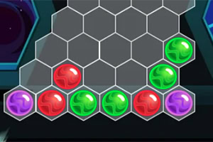 Färgade sfärer med röda, gröna och lila nyanser arrangerade på ett hexagonalt rutnät
