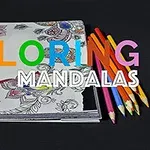 En ritbok med delvis färglagda mandala-mönster och färgpennor placerade ovanpå, med texten COLORING MANDALAS i flerfärgad och vit skrift