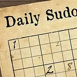 Ett delvis ifyllt sudokupussel på gammalt papper med en fjäderpenna bredvid