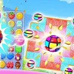 En färgglad illustration med två spelplaner fyllda med olika symboler som frukter, godis och stjärnor, samt explosionseffekter och ljusa bollar