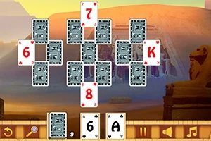 Kort placerade i ett geometriskt mönster mot en bakgrund av en egyptisk öken med pyramider och statyer