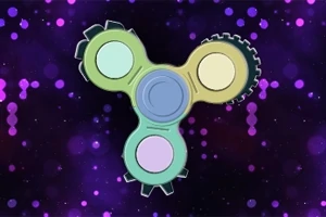 Fidget spinner med kugghjul i pastellfärger mot en bakgrund av lila och rosa prickar