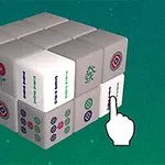 En 3D-kub av mahjong-brickor med olika symboler visas på en grön bakgrund med en vit pekhand som indikerar en specifik bricka