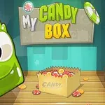 En grön tecknad figur med stora ögon bredvid en låda full med godis under texten My Candy Box