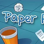 Texten Paper Flick visas med ett skrivbord innehållande ett papper, en papperskorg och en fläkt i bakgrunden