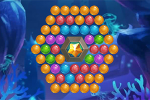 Färgglada bollar arrangerade i ett hexagonalt mönster kring en centralt placerad orange diamant på en mörkblå bakgrund