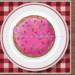 Tallrik med en kaka med rosa glasyr och strössel, omgiven av bestick på en rutig bordsduk