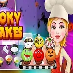 Tecknad kock i vit hatt med bricka av halloween-cupcakes bredvid texten Spooky Cupcakes och bakelseingredienser i bakgrunden