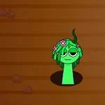 Grön figur med blommor på huvudet som sticker upp ur marken mot en brun bakgrund
