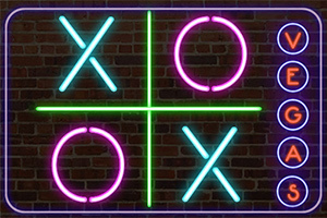 Neonskylt med kryss och cirklar mot en tegelvägg, samt ordet VEGAS lodrätt till höger